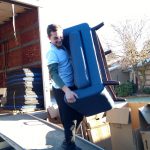 Burnaby Movers Signature Moving carrying a chair 778-325-6683